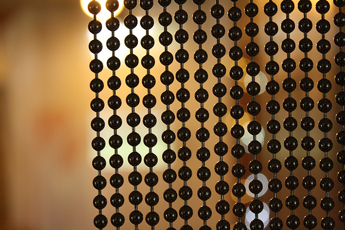 Black beaded curtains can be used in a reception area as a screen
