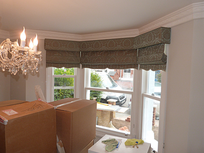 New roman blind installation in sitting room
